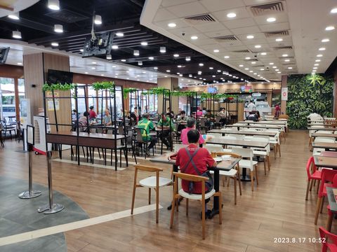 Spacious Food Court with Dining Areas and Biophilic Green Wall