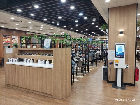 Modern Cafeteria with Wood Accents and Digital Kiosk
