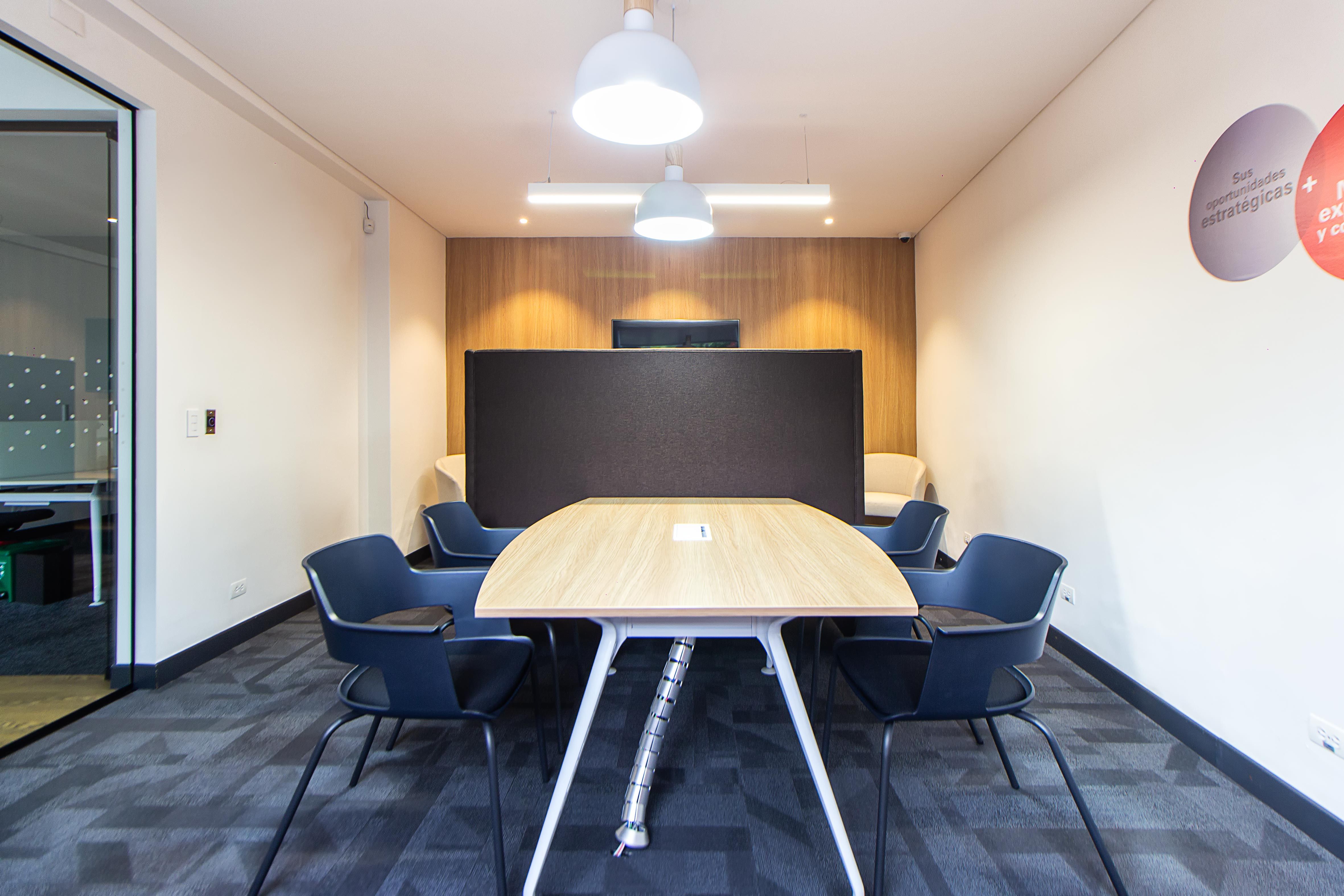 Contemporary conference room with stylish furniture and lighting, ideal for meetings.