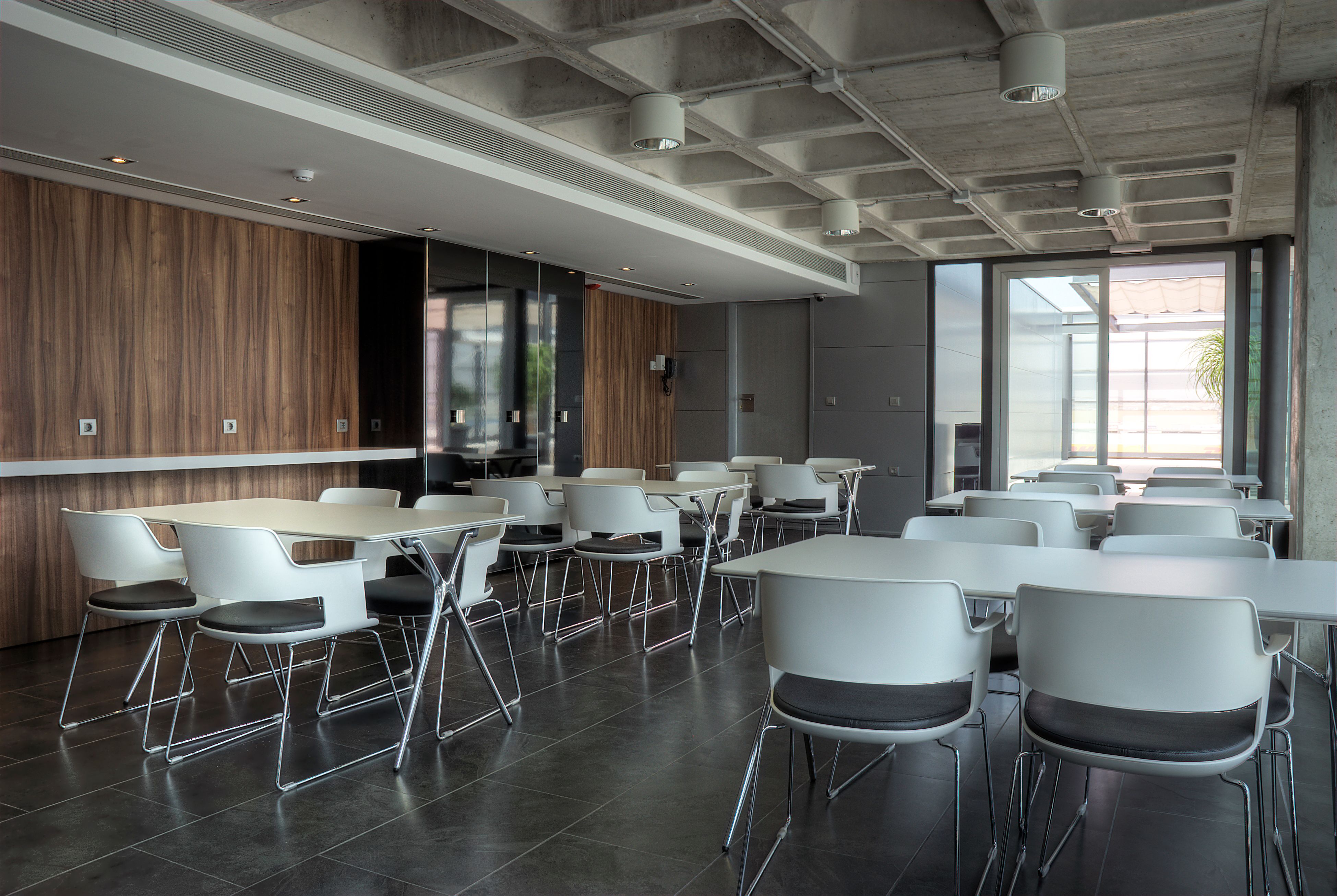 Spacious cafeteria with sleek tables, chairs, and modern design elements.